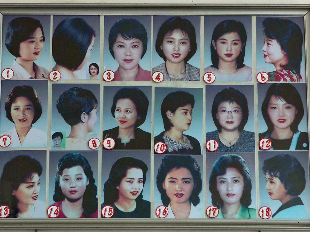 A poster showing different types of hair styles worn by North Korean men  hangs outside a barber shop at the Munsu water park on Tuesday Dec 1  2015 in Pyongyang North Korea 