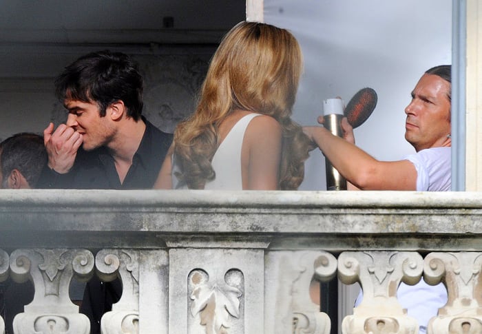 Ian Somerhalder bites his cuticles while hairstylist Maxime Mace uses Elnett hairspray on Ana Beatriz Barros