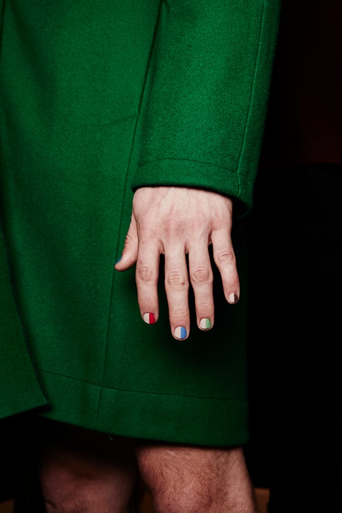male model wears split screen Essie manicure