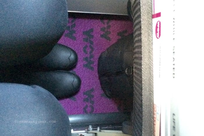 I'm sitting straight up in a Wow Air seat 4A, marvelling at the leg room as well as the magenta carpet.