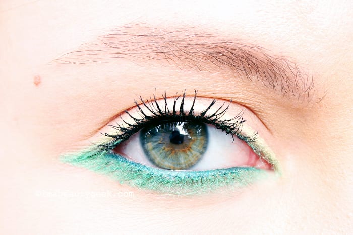 Erin wears Make Up For Ever Aqua XL waterproof eye pencil in M-40 Matte Yellow, M-34 Iridescent Pop Green, and along her lower waterline, I-24 Iridescent Blue