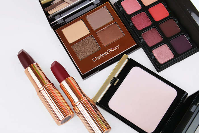 Charlotte Tilbury Matte Revolution Lipstick in Opium Noir and Red Carpet Red, and eye shadow quad in Golden Goddess; Viseart Petit Pro Palette 2; Kevyn Aucoin The Guardian Angel Cream Highlighter
