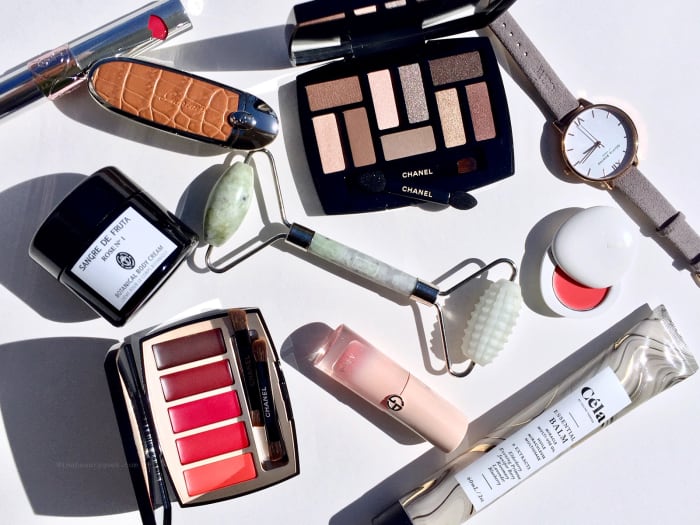 Clockwise from top left: Yves Saint Laurent Volupté Liquid Color Balm, Guerlain Rouge G Customizable Lipstick and Case, Chanel Les Beiges Natural Eyeshadow Collection, Olivia Burton London watch, Lilah B Tinted Lip Balm, Céla Essential Balm, Giorgio Armani Neo Nude A-Blush, Province Apothecary Dual Action Jade Facial Roller, Chanel La Palette Caractère Lipstick Palette, and Sangre De Fruta Rose Nº1 Botanical Body Cream
