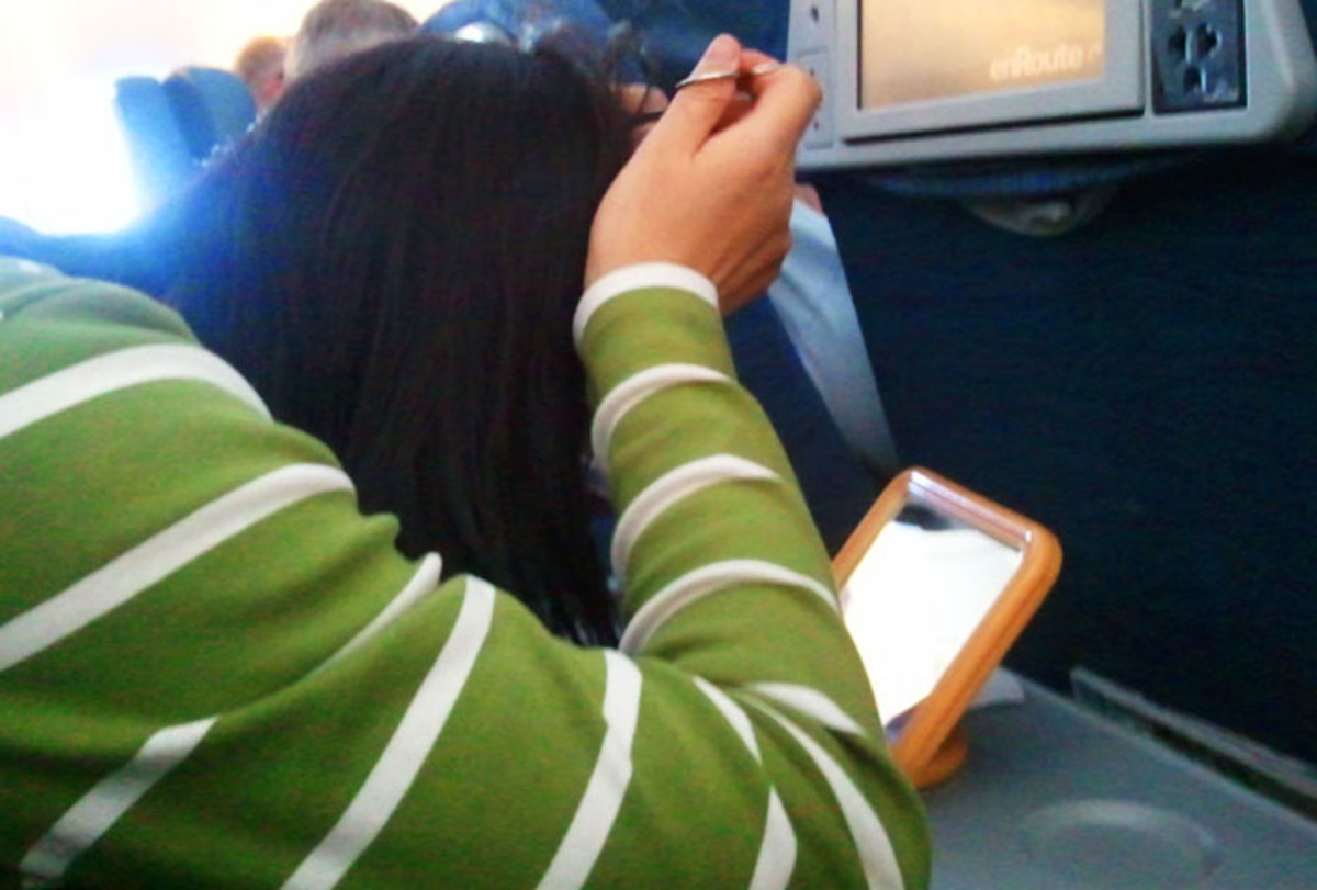 public grooming: woman plucking grey hairs on a five-hour flight