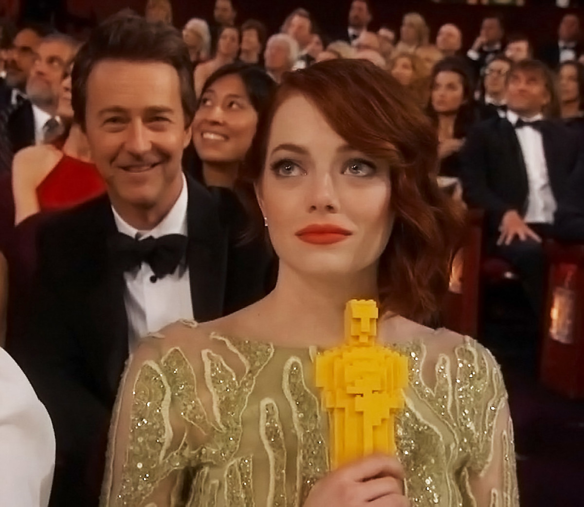 Emma Stone at the 2015 Oscars with a LEGO Academy Award_makeup by Revlon and Chanel